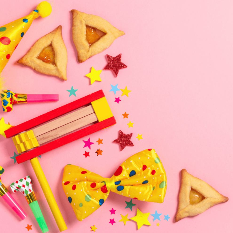 Colorful Purim celebration items on a pink background, including hamantaschen cookies, a noise maker, confetti, a party hat, and a polka dot bow tie.